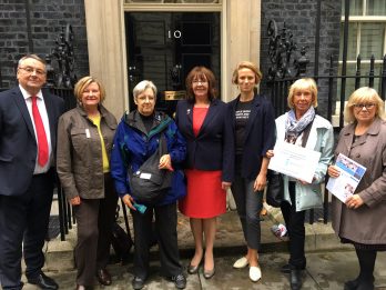 representatives-from-stop-the-traffik-and-soroptimist-international-northern-england-stand-outside-the-door-of-10-downing-street